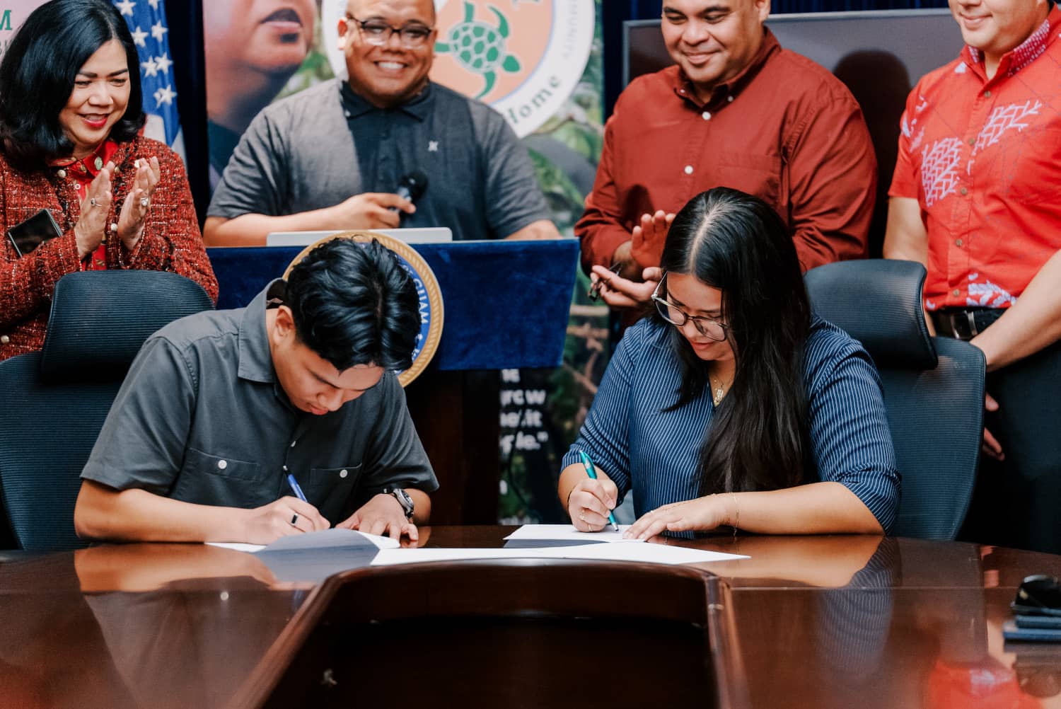 Miguel Cordero and Preya Camacho sign their official starting documents