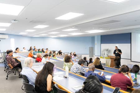 Attendees listen in on a presentation by Dr. Carlos Madrid