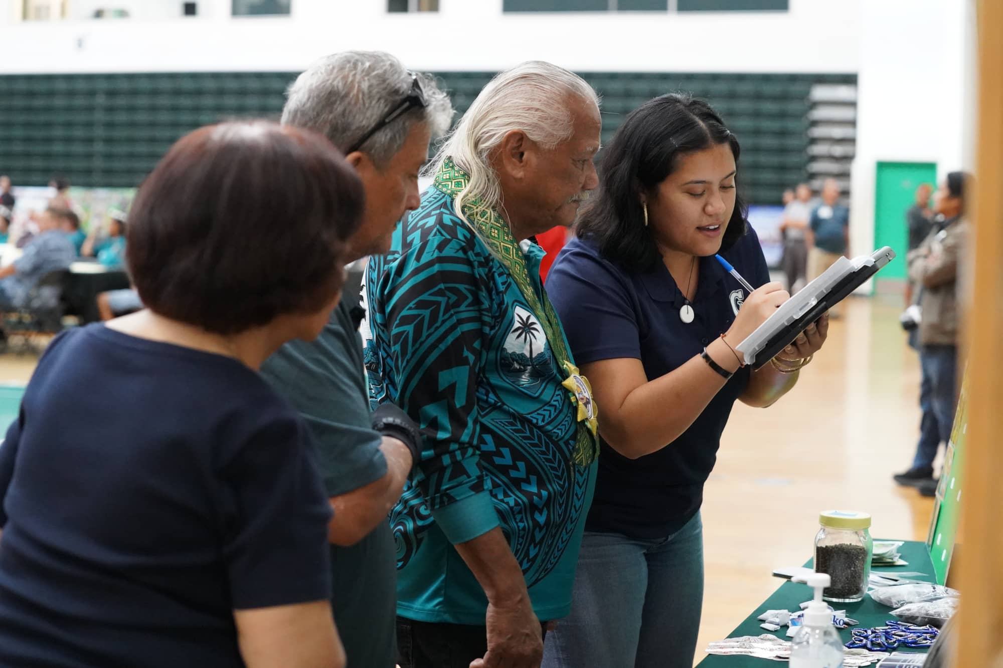 Cecilia Pangelinan gathers information from Vice Mayor of Tamuning Albert Toves and other residents