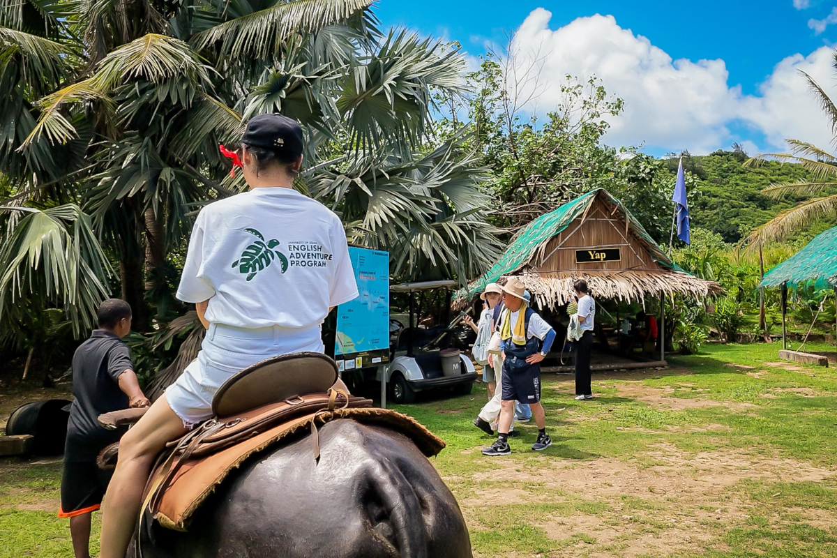 Student riding a carabao