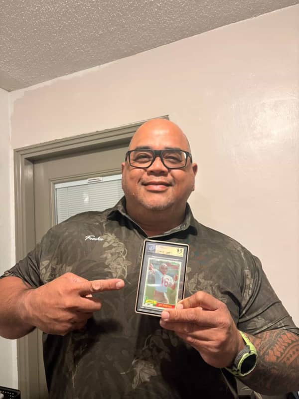 Roland holding a card