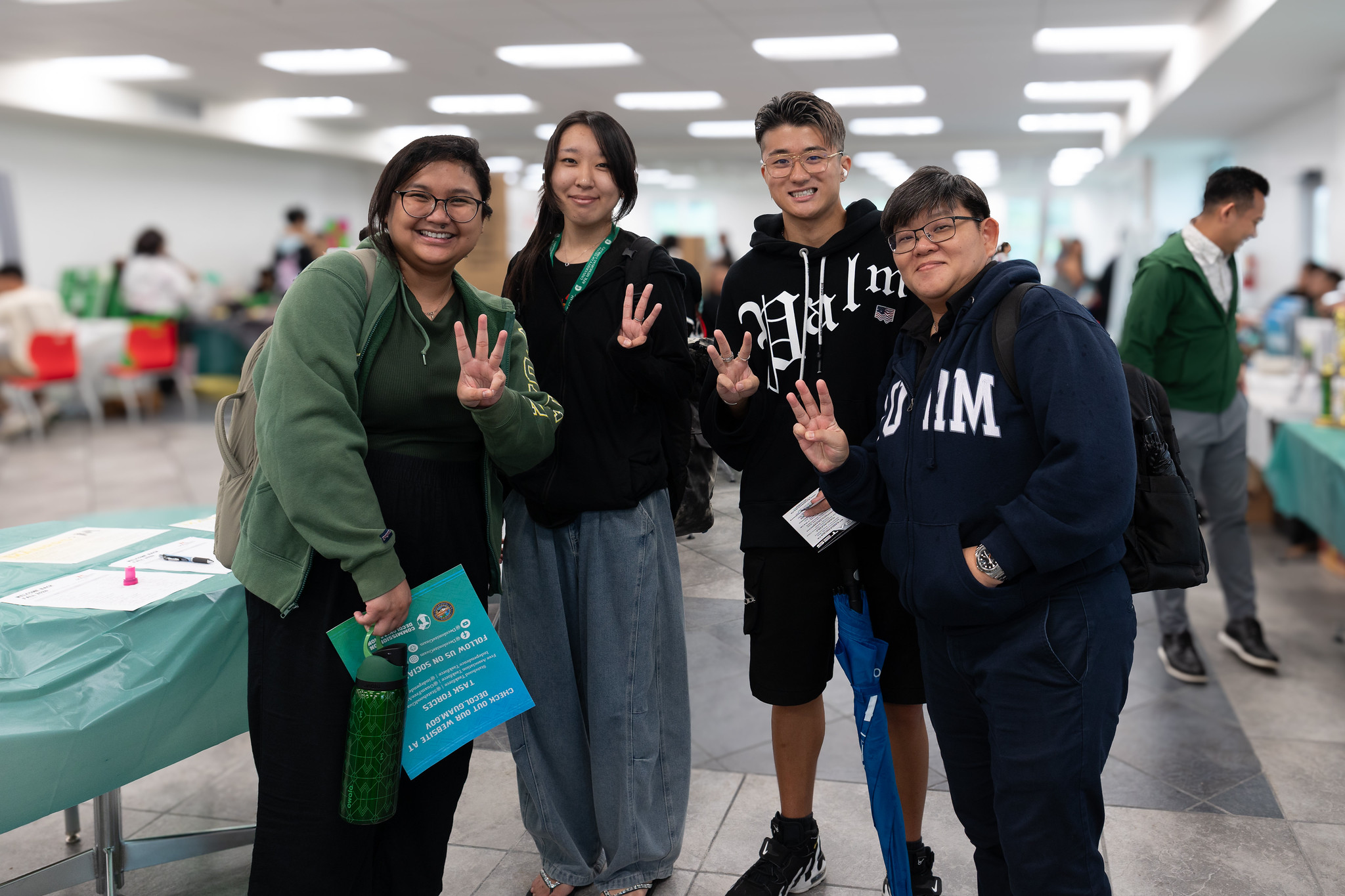 Group photo of four students during a campus welcome event.