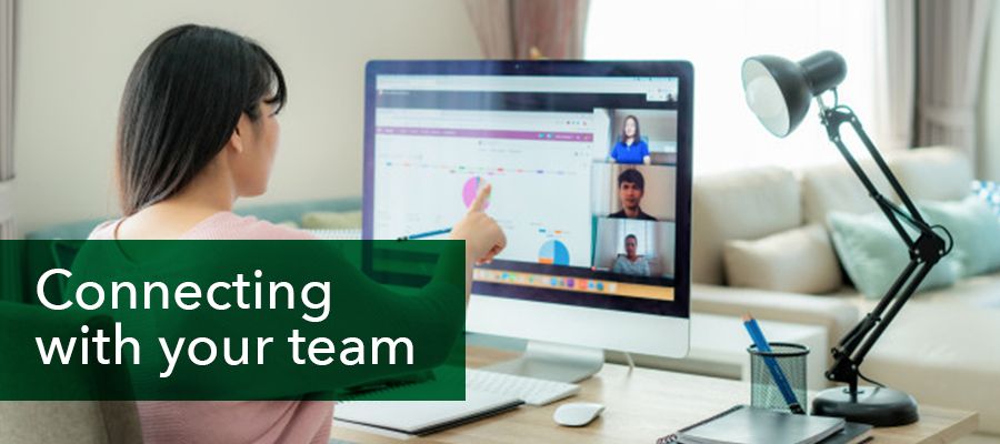 Connecting with your team: Photo of a lady working while video conferencing with her colleagues.